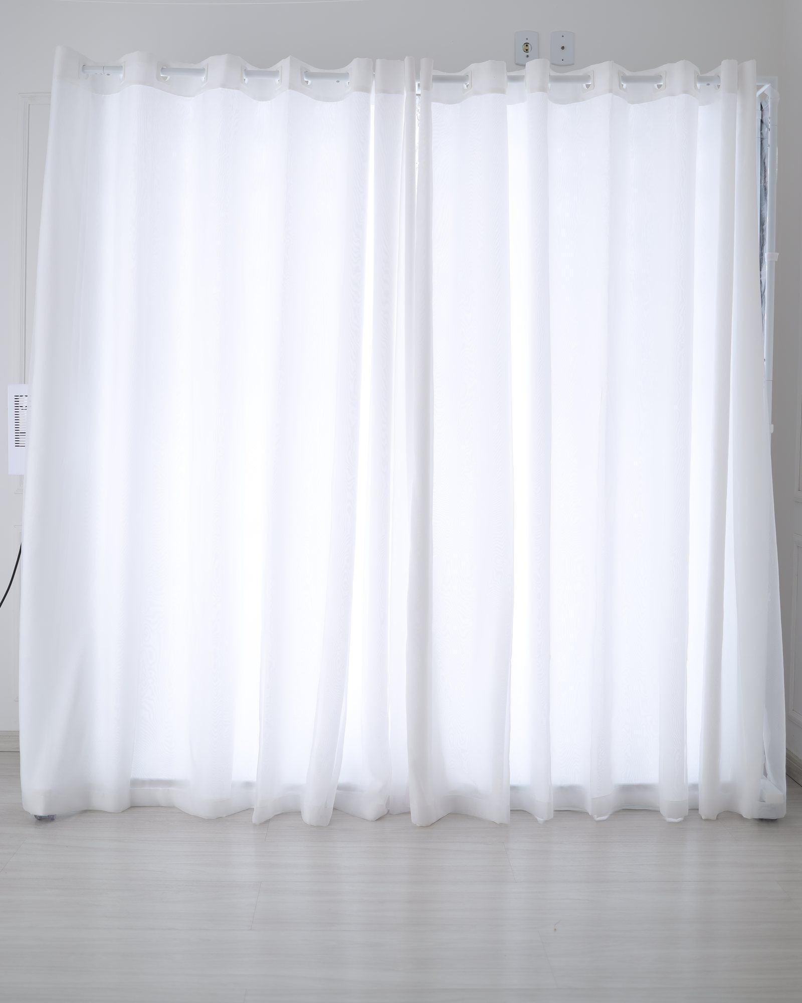 LEDWindow PRO+ seen from the front, lit, with the curtain down to the floor and the base hidden behind it